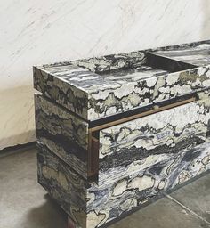 a marbled box with two drawers on wheels