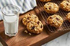 oatmeal cookies on a cooling rack next to a glass of almond milk