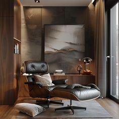 an eames chair and ottoman in front of a large window with a painting on the wall