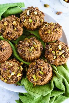 a white plate topped with muffins covered in nuts