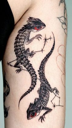 a black and white photo of a dragon tattoo on the side of a woman's thigh