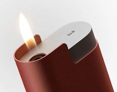 a red lighter with a lit flame in it