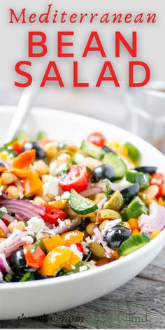 mediterranean bean salad with feta cheese and olives in a white bowl