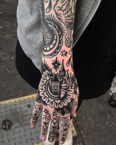 a person with tattoos on their arm and hand