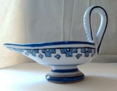 a blue and white bowl sitting on top of a table