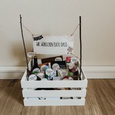 a wooden box filled with lots of different types of buttons and magnets next to a white wall