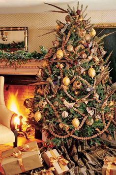 a decorated christmas tree in front of a fireplace