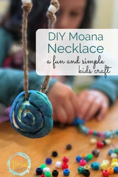 a child is playing with beads on a table and the words diy moan necklace are in