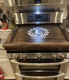 a stainless steel oven with a wooden top and two burners on the stovetop