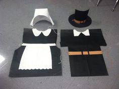 some paper bags that have been cut out to look like people in hats and gowns