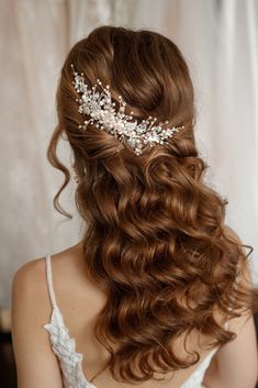 the back of a woman's head wearing a bridal hair comb