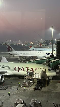 there are many airplanes that are parked at the airport and one is on the tarmac