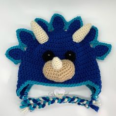 a crocheted blue and white hat with an animal's face on it