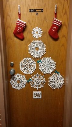 a door decorated with snowflakes and stockings