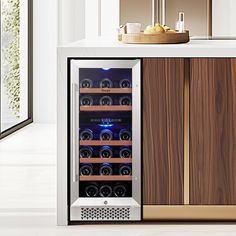 a wine cooler sitting on top of a white counter next to a wooden cabinet filled with bottles