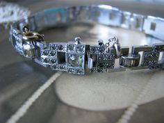 "This is a dazzling 1930's Art Deco paste/rhinestone bracelet. It measures 5/8'' at widest x 7 1/4'' long with a safety catch chain. Signed \"CZECHOSLOVAKIA\" on the clasp pin. In beautiful condition with just a few of the channel set stones absent. *SEE THE LAST PIC FOR THIS DETAIL. The stones have been beautifully subdued by time so they have a mysterious glimmer. Some are yellowed by the old original glue. There is some wear to the silver finish as to be expected for an item of it's age. This Victorian Jeweled Wedding Bracelets, Vintage Jubilee Bracelets For Wedding, Vintage Jeweled Bracelets For Wedding, Art Deco Wedding Bracelet Jewelry, Antique Hand-set Bracelets For Weddings, Art Deco Diamond Bangle Bracelet For Wedding, Antique Hand-set Bracelet For Weddings, Antique Hand-set Wedding Bracelet, Antique Hand Set Bracelet For Weddings