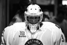 a close up of a person wearing a hockey uniform with a badge on his chest