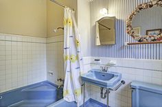 a bathroom with a sink, tub and mirror