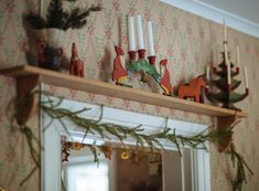 a fireplace mantel with christmas decorations on it