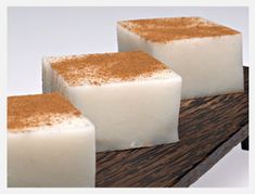 three bars of soap sitting on top of a wooden table