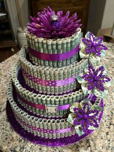 a cake made out of stacks of money with purple flowers on top and the words would you like to have this cake for new year?