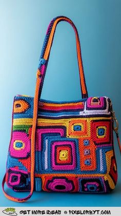 a colorful crocheted bag is shown on a blue background