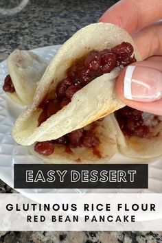 a hand is holding a piece of food on a plate with the words glutinoous rice flour red bean pancake