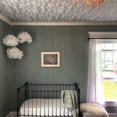 a bed room with a neatly made bed and a painting on the wall above it