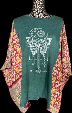 Get ready to spread your wings and fly high in our Celestial Butterfly shirt! With its stunning butterfly design and intricate details, you'll be the talk of the town. *Handmade; Hand sewn. Made from up-cycled imported kantha quilt! One-Size-Fits-All. Green Patchwork Tops For Festival, Bohemian Cotton Tops With Butterfly Print, Celestial Butterfly, Spread Your Wings And Fly, Butterfly Shirt, Butterfly Shirts, Womens Blouses, Fly High, Scottsdale Az