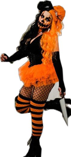 a woman dressed up as a witch holding a knife and wearing an orange dress with black stripes