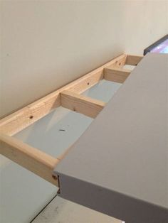 an unfinished table with two drawers on each side