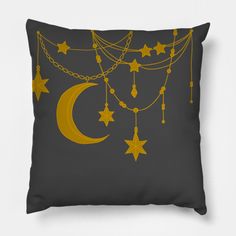 a gray pillow with gold stars and chains hanging from it