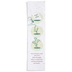 a white bookmark with green plants on it