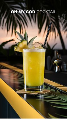 a yellow cocktail with a pineapple garnish on the rim