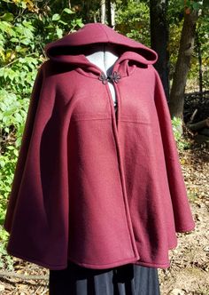 This short cloak is delightfully soft and comfortable. It's long enough to reach the back of the hand, keeping you warm but keeping your hands available when needed. It has a full hood and closes with a matching cloth frog clasp. This cloak is great for a costume piece or a cozy jacket, great for Spring, Fall, or over air conditioned buildings.Your cloak will measure about 30 inches in length. This listing is in a lovely burgundy wine color but other colors are available in my store or on reques Solid Hooded Cape For Fall, Hooded Cape For Larp In Fall, Hooded Fall Cape For Larp, Hooded Poncho For Cold Weather And Fall, Hooded Poncho For Cold Weather In Fall, One Size Hooded Cape For Fall, One Size Cape For Outdoor, One Size Hooded Outerwear For Outdoor, One-size Hooded Outerwear For Outdoor