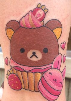 a bear with a cupcake tattoo on its leg