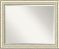 a white framed mirror on a wall