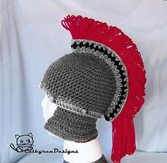 a crocheted hat with red hair on top of a mannequin head