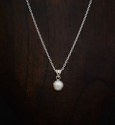 A beautiful white freshwater pearl in a simple sterling silver setting with a sterling silver 16"-18" trace chain.  Dimensions: Pearl: 8mm diameter. Pendant Length: 1.5cm including bail. Chain: 16" extendable to 18".  Materials: Sterling Silver White Freshwater Pearl  Beyond Biasa creates unique jewellery that is inspired by antique and tribal designs from around the globe. All of our pieces are handmade so please allow for slight variations in size and colour. Sterling Silver Necklace With Pearl Charm, Sterling Silver Pearl Necklace For Everyday, Silver Pendant Pearl Necklace For Everyday, Everyday White Gold Pearl Necklace In Sterling Silver, Everyday White Gold Sterling Silver Pearl Necklace, Delicate Silver Pearl Necklace With Round Pendant, Silver Sterling Silver Pearl Necklace With Pearl Charm, Everyday Sterling Silver Pearl Pendant Necklace, Classic Sterling Silver Pearl Necklace For Everyday