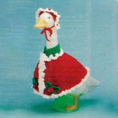 a knitted duck wearing a red and green dress