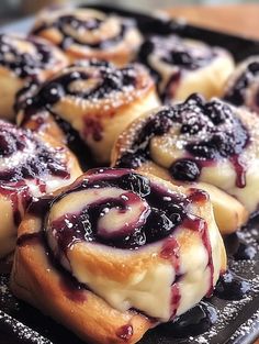 some blueberry rolls are on a black plate