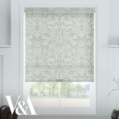 a window with roman blinds in green and white