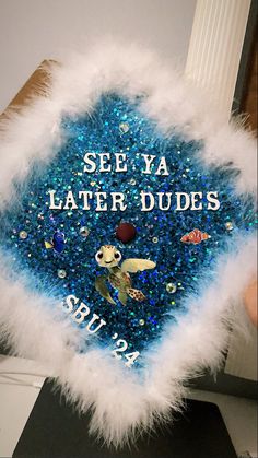 a blue and white graduation cap that says see ya later dudes