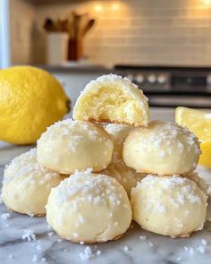 a pile of lemon cookies sitting on top of a counter