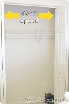 an empty closet with two yellow arrows pointing to the dead space