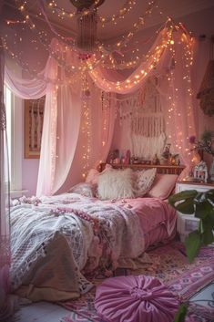 a pink bedroom with fairy lights hanging from the ceiling and bedding on the floor