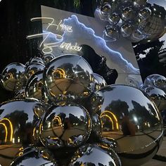 many shiny balls are in front of a sign