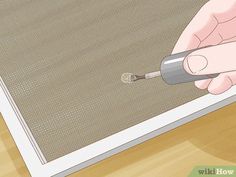 a person using a screwdriver to fix a screen door