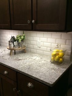 a kitchen counter with some lemons on it