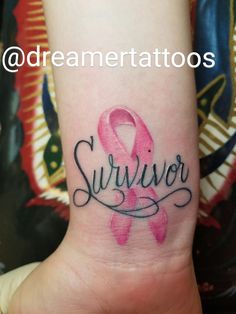 a small wrist tattoo with the word survivor written on it and a pink ribbon in black ink